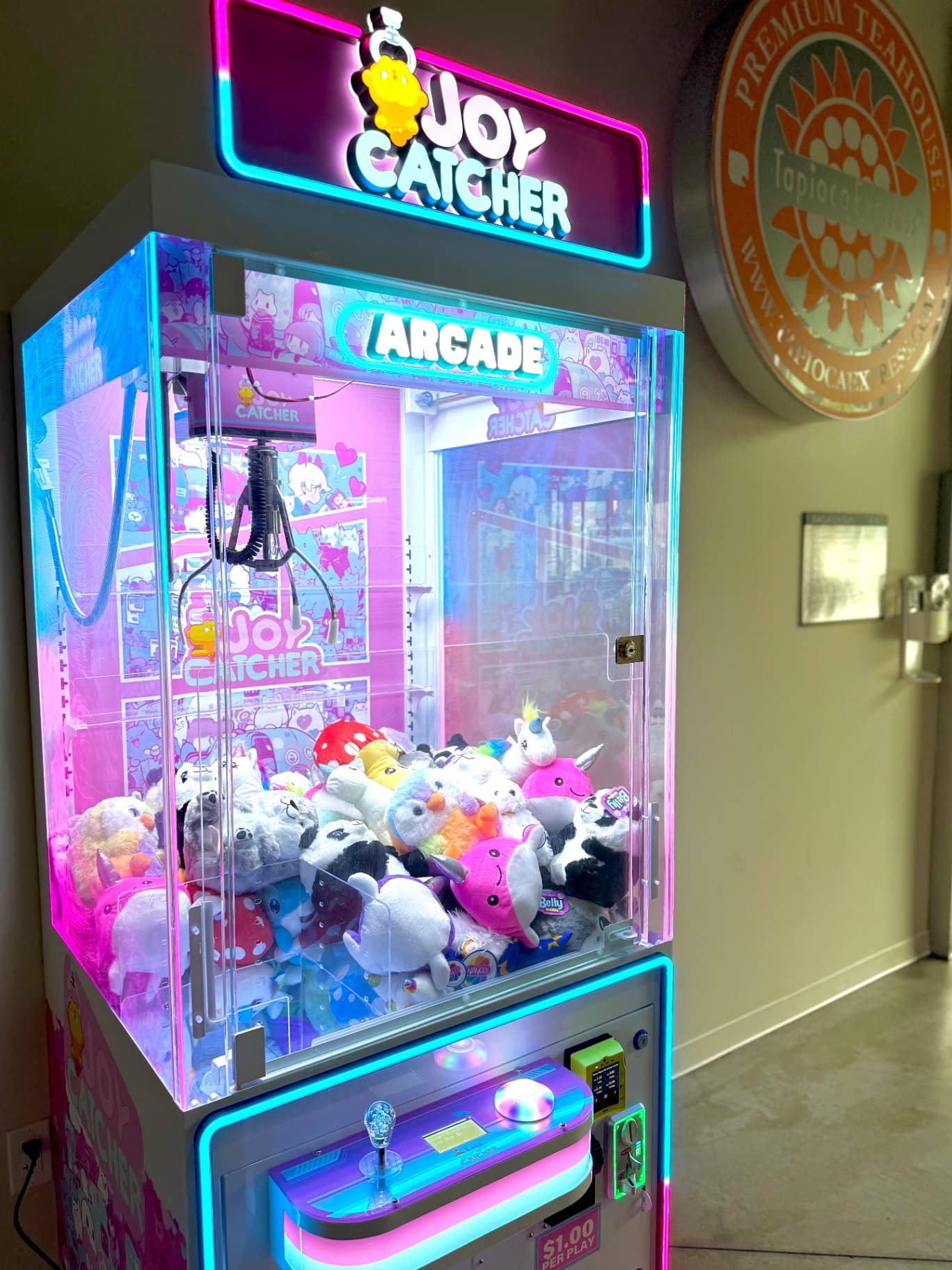 Joy Catcher claw machine filled with plush prizes